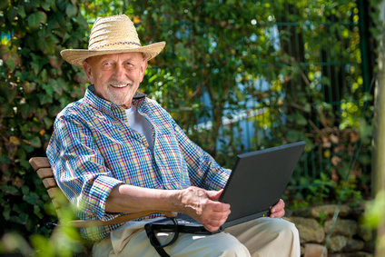 Mann mit Laptop im Grünen
